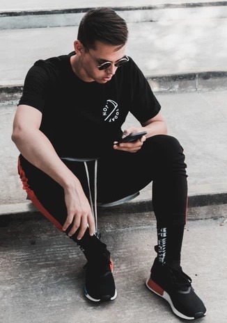 Man in black T-shirt using a mobile phone
