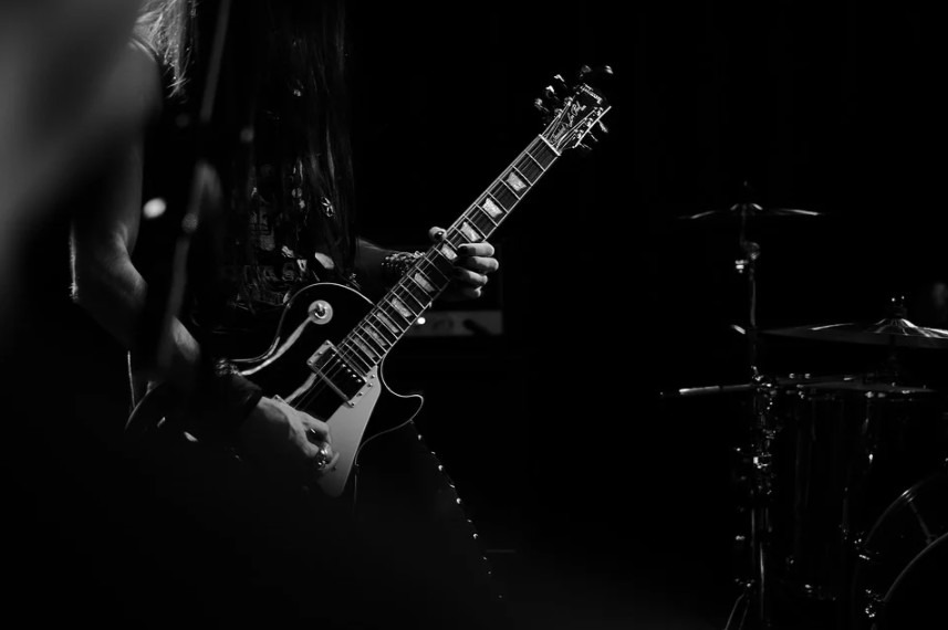 Man playing guitar in black-and-white
