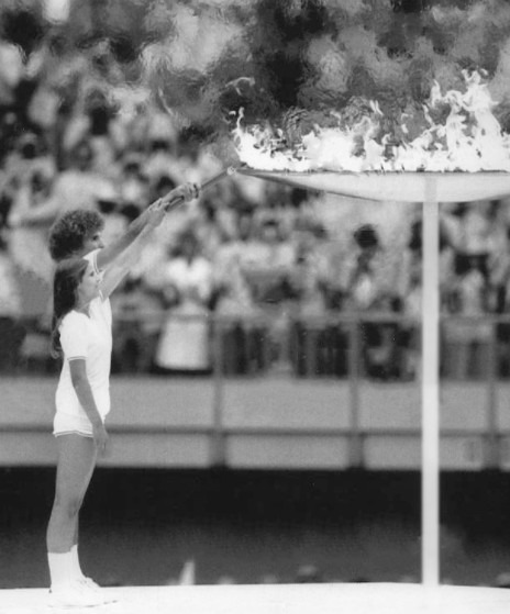Préfontaine and Henderson lighting the Olympic Flame