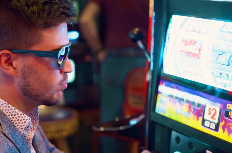 a man playing a slot machine