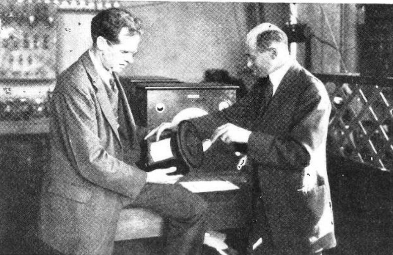 Kellogg and Rice in 1925 holding the large driver of the first moving-coil cone loudspeaker.