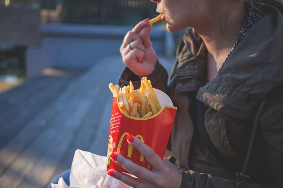 person eating some McDonald’s fries