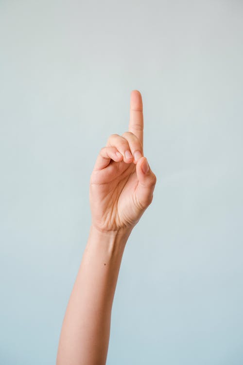a hand with the pointer finger pointing upwards