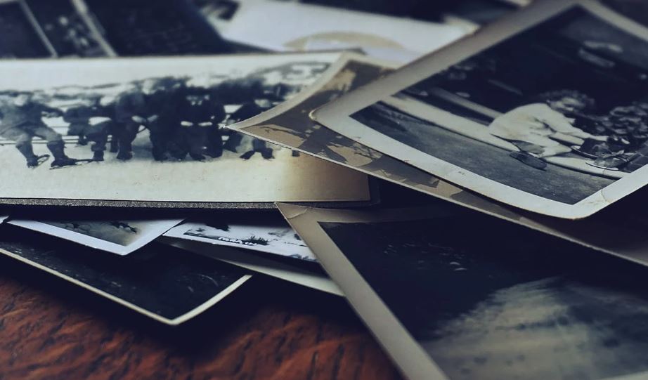 a pile of old photographs on a table