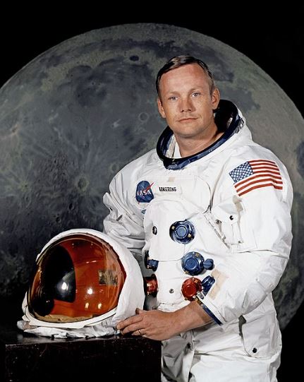 Neil Armstrong holding his helmet 