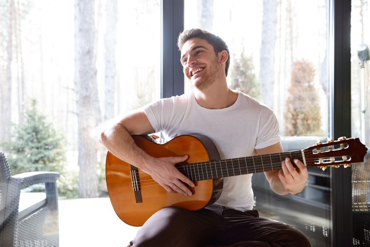 smiling man with guitar