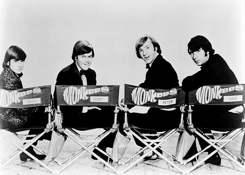 The Monkees with Michael Nesmith sitting on the farthest left seat