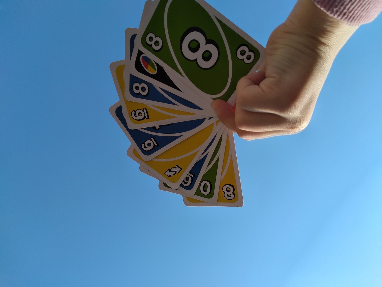a person holding UNO cards