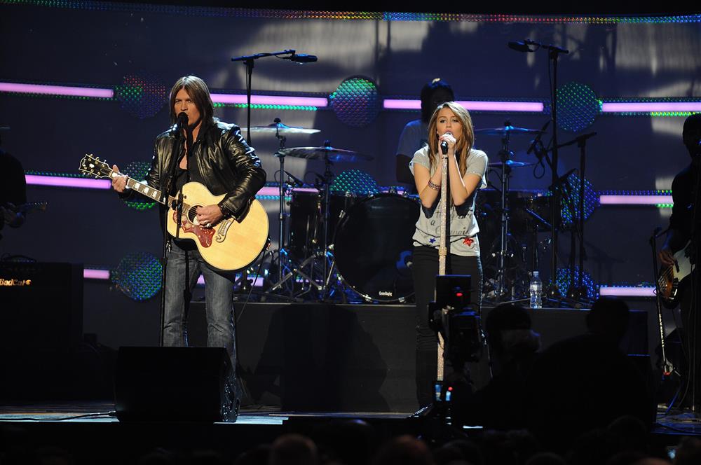 Miley Cyrus and Billy Ray Cyrus performing "Ready, Set, Don't Go" at a 2009 concert