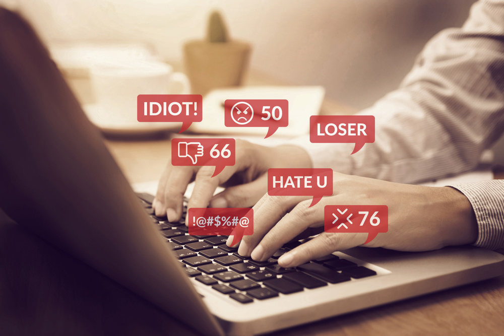Cyber bullying concept. people using notebook computer laptop for social media interactions with notification icons of hate speech and mean comment in social network