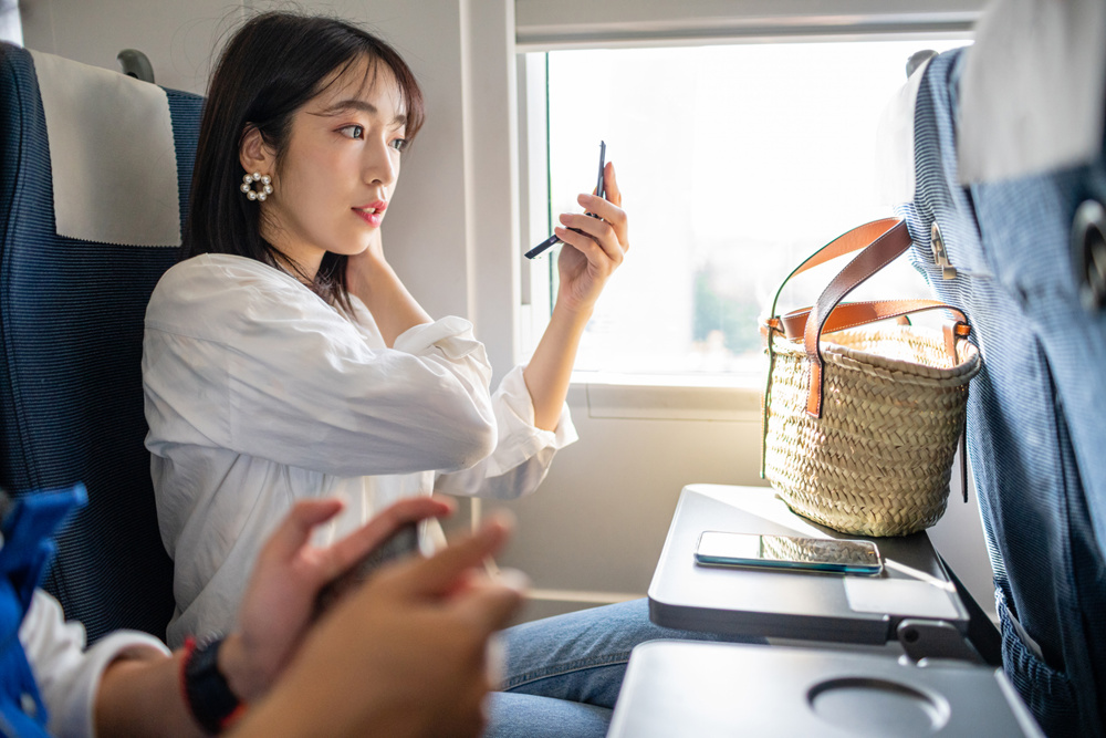 A Chinese Women making up on train
