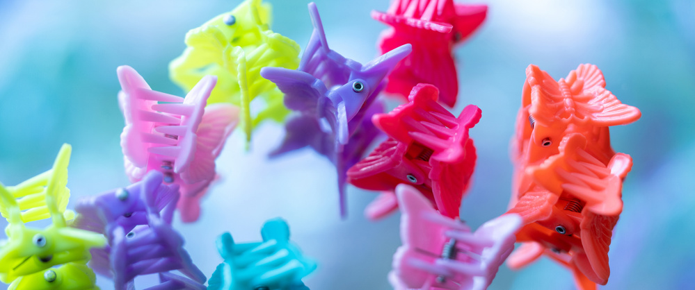 Macro image of rainbow colored butterfly-shaped hair clips
