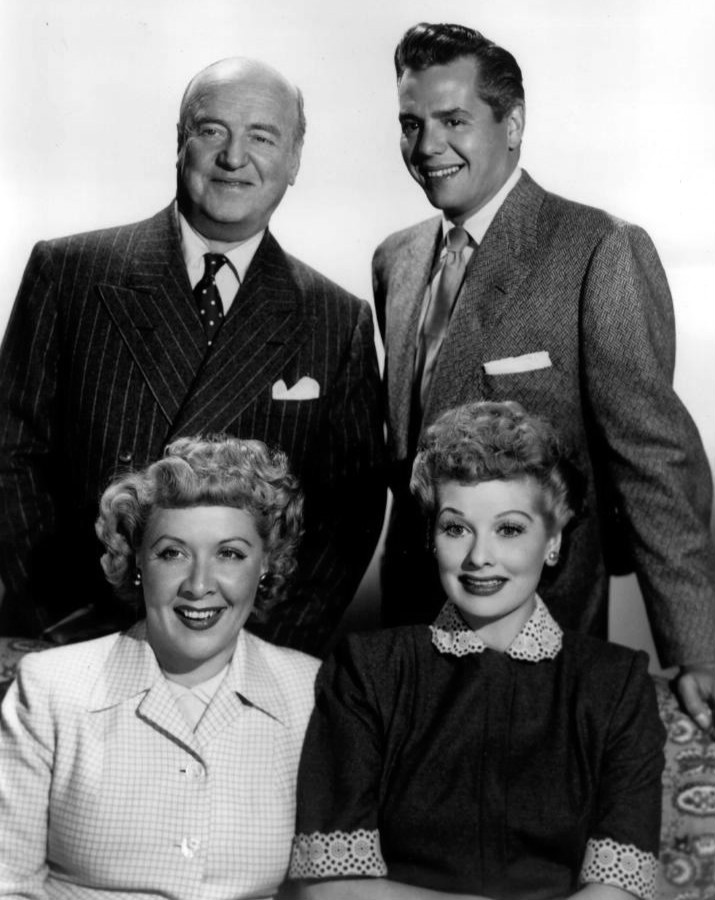 Cast members from left standing William Frawley Desi Arnaz seated Vivian Vance and Lucille Ball