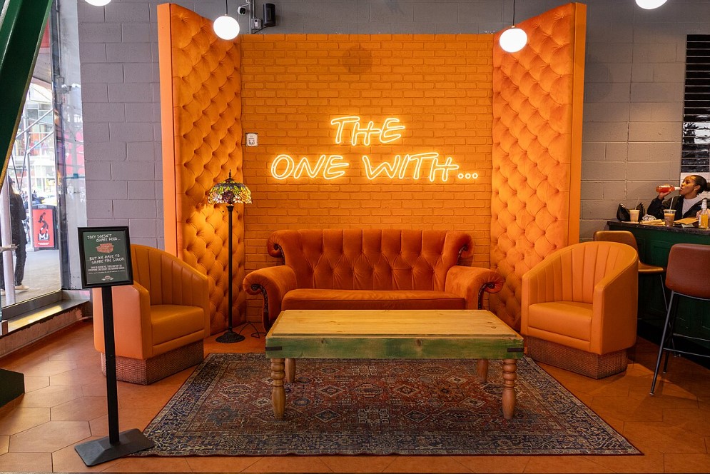 A replica of the famed orange sofa from the fictional Central Perk from the show at the Times Square Central Perk coffee shop in May 2026.