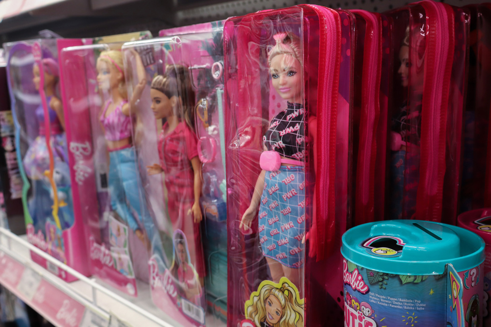 Saint-Petersburg, Russia - 10 August 2024. Row of Barbie dolls are on a shelf. The dolls are in plastic cases and are in different colors