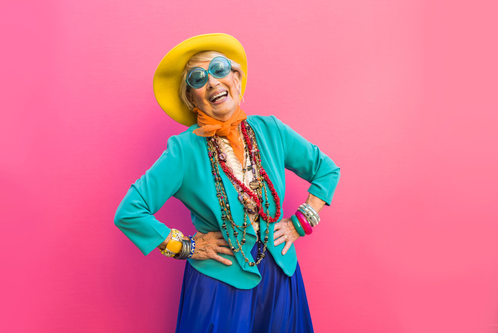 Happy and playful senior woman having fun - Portrait of a beautiful lady above 70 years old with stylish clothes, concepts about senior people