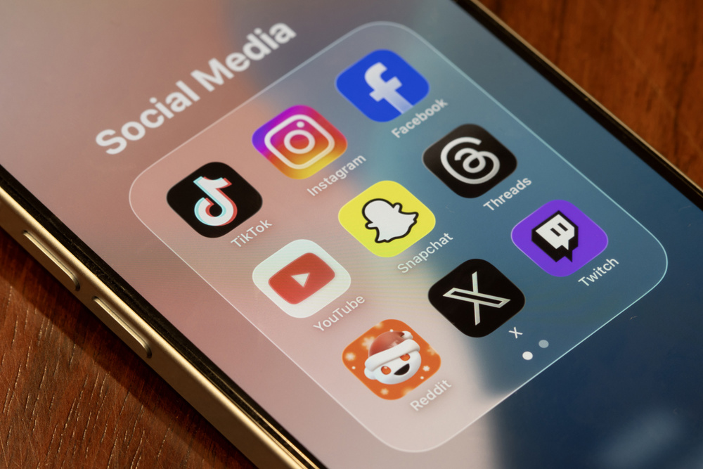 Portland, OR, USA - Dec 18, 2025: Assorted apps (TikTok, Instagram, Facebook, YouTube, Snapchat, Threads, Reddit, X, and Twitch) included in Australia's world-first teen social media ban are seen on the screen of an iPhone